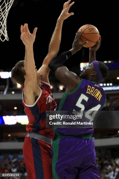 Kwame Brown of the 3 Headed Monsters attempts a shot while being guarded by Lou Amundson of Tri-State during week six of the BIG3 three on three...