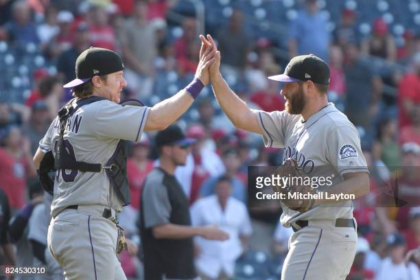 Greg Holland#56 of the Colorado Rockies celebrates a win with Ryan Hanigan of the Colorado Rockies after game one of a doubleheader baseball game...