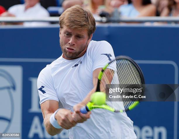 Ryan Harrison returns a backhand to John Isner during the BB&T Atlanta Open at Atlantic Station on July 30, 2017 in Atlanta, Georgia.