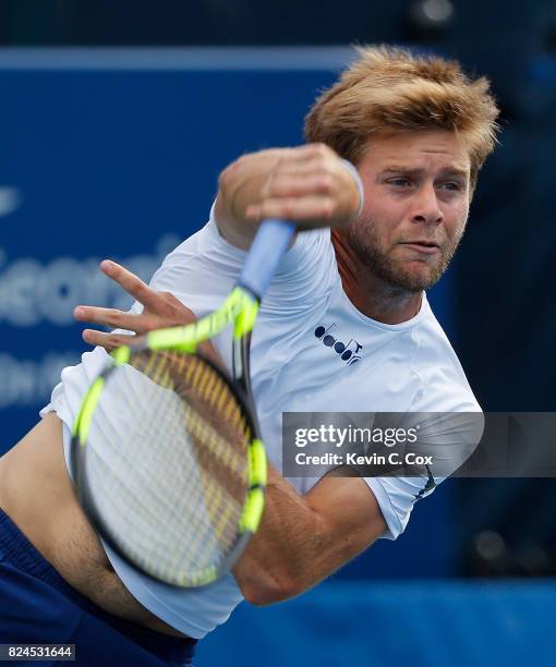 Ryan Harrison serves to John Isner during the BB&T Atlanta Open at Atlantic Station on July 30, 2017 in Atlanta, Georgia.