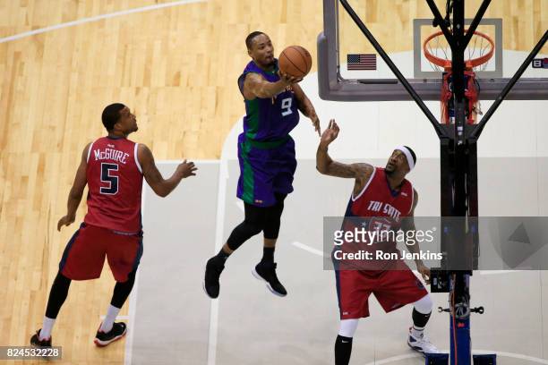 Rashard Lewis of the 3 Headed Monsters attempts a shot between Dominic McGuire and Lee Nailon of Tri-State during week six of the BIG3 three on three...