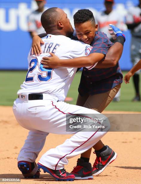 Adrian Beltre of the Texas Rangers hugs his son Adrian Jr. After hitting his 3000th MLB career hits in the fourth inning against the Baltimore...