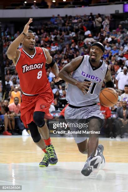 Ricky Davis of the Ghost Ballers dribbles the ball while being guarded by James White of Trilogy during week six of the BIG3 three on three...