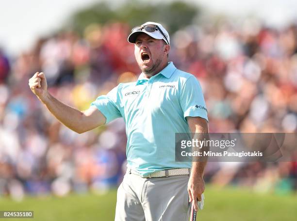 Robert Garrigus of the United States reacts to his putt on the 18th hole during the final round of the RBC Canadian Open at Glen Abbey Golf Club on...