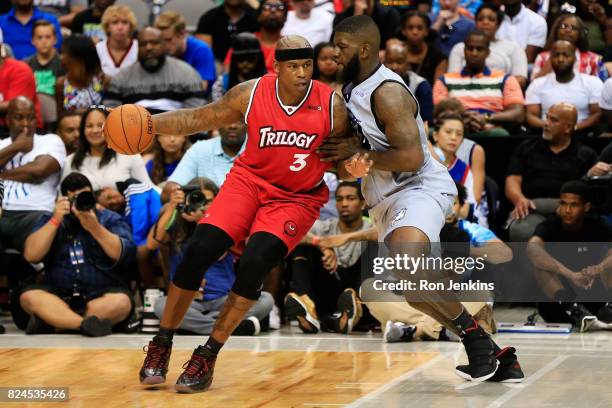 Al Harrington of Trilogy dribbles the ball while being guarded by Ivan Johnson of the Ghost Ballers during week six of the BIG3 three on three...