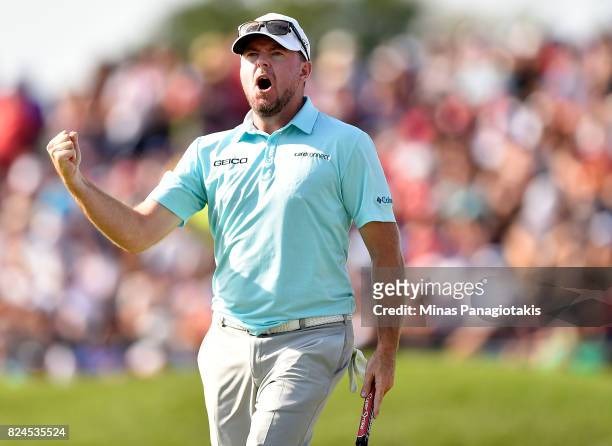 Robert Garrigus of the United States reacts to his putt on the 18th hole during the final round of the RBC Canadian Open at Glen Abbey Golf Club on...