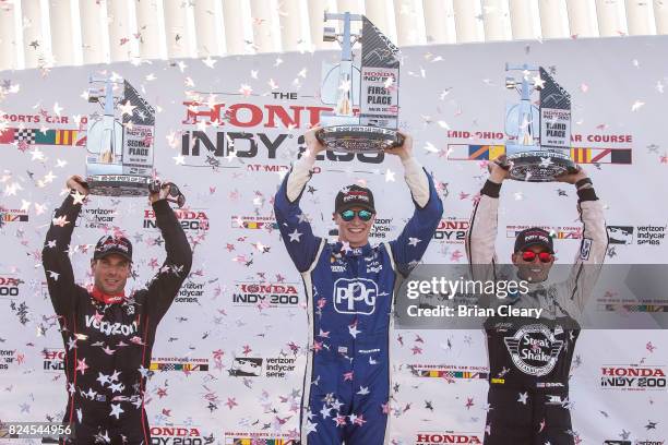 Podium finishers, left to right, Will POwer, of Australia, Josef Newgarden, and Graham Rahal celebrate after the Verizon IndyCar Series Honda Indy...