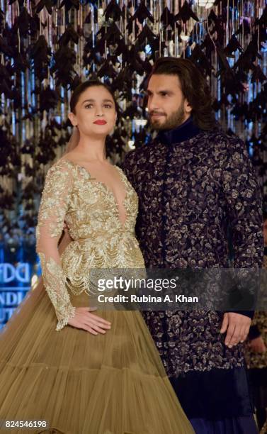 Bollywood actors, Alia Bhatt and Ranveer Singh walk for Manish Malhotra during FDCI's India Couture Week 2017 at the Taj Palace hotel on July 30,...