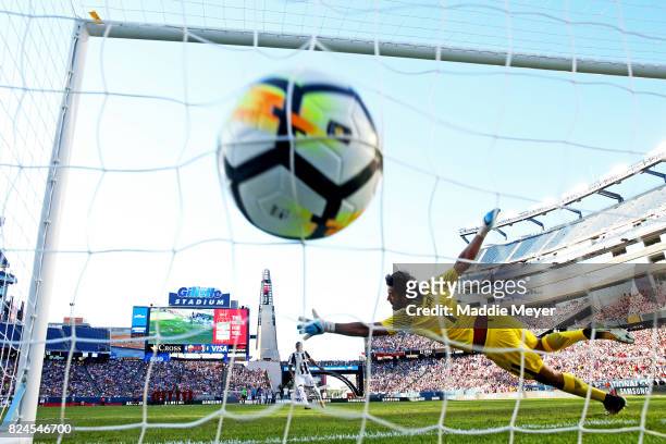 Douglas Costa of Juventus scores the game winning penalty kick against Alisson Becker of Roma during the International Champions Cup 2017 match at...