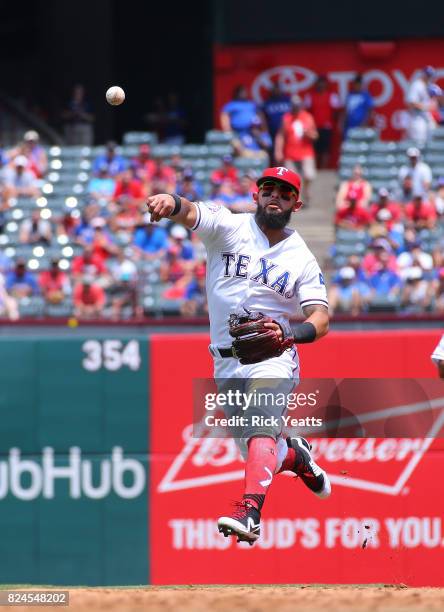 Rougned Odor of the Texas Rangers throw the runner out on first base in the third inning against the Baltimore Orioles at Globe Life Park in...