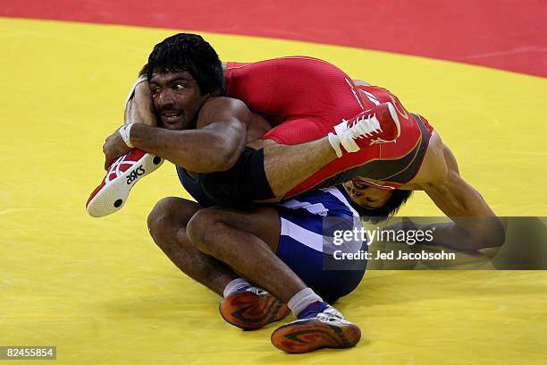 Kenichi Yumoto of Japan competes against Yogeeshwar Dutt of India in the men's 60 kg wrestling event at the China Agriculture University Gymnasium on...