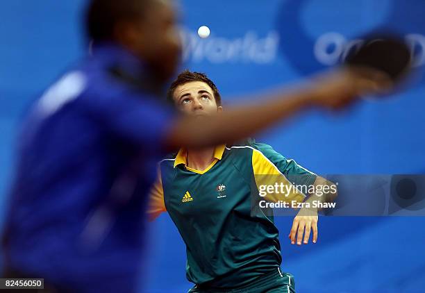 William Henzell of Australia plays against Idir Khourta of Algeria during the Men's Singles Preliminary Round held at the Peking University Gymnasium...