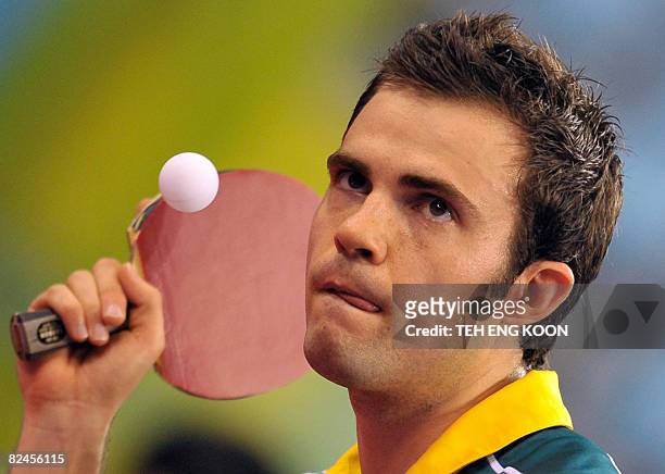 Australia's William Henzell serves to Algeria's Idir Khourta during their men's table tennis single preliminary match as part of the 2008 Beijing...