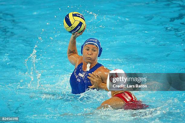 Cinzia Ragusa of Italy looks to pass over the defense of Teng Fei of China in the women's classification 5th-6th place match at the Ying Tung...