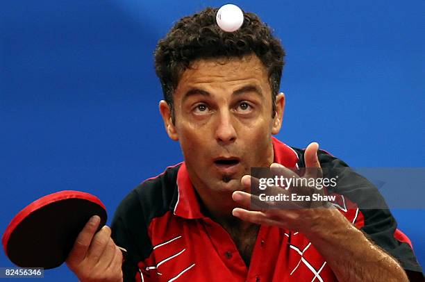 Adel Massaad of Eygpt serves to Alfredo Carneros of Spain during the Men's Singles Preliminary Round held at the Peking University Gymnasium during...