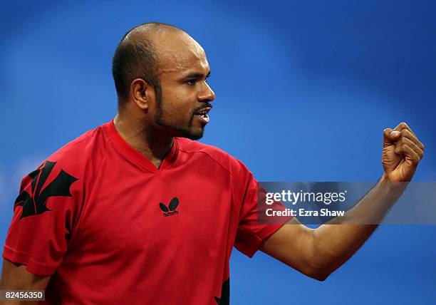 Pradeeban Peter-Paul of Canada celebrates while playing against Gustavo Tsuboi of Brazil during the Men's Singles Preliminary Round held at the...