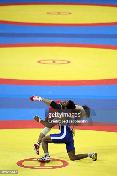 Kenichi Yumoto of Japan competes against Yogeshwar Dutt of India in the 60 kg freestyle wrestling event at the China Agriculture University Gymnasium...