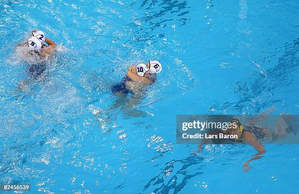 The United States team celebrates winning the women's water polo semifinal round 9-8 over Australia at the Ying Tung Natatorium on Day 11 of the...