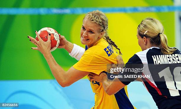 Sara Eriksson of Sweden vies with Gro Hammerseng of Norway during their 2008 Beijing Olympic Games women's handball quarterfinal match on August 19,...
