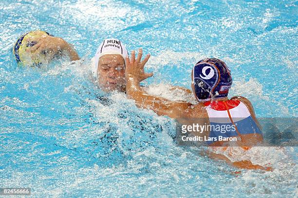 Anett Timea Gyore of Hungary fights Gillian Van Den Berg of Netherlands during the women's water polo semifinal round at the Ying Tung Natatorium on...