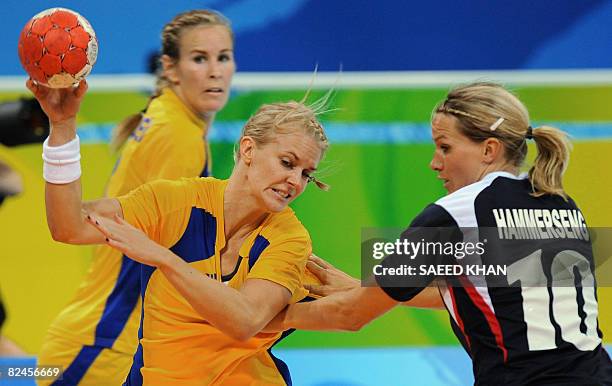 Sara Eriksson of Sweden vies with Gro Hammerseng in the 2008 Beijing Olympic Games women's handball quarterfinal match on August 19, 2008. Norway won...