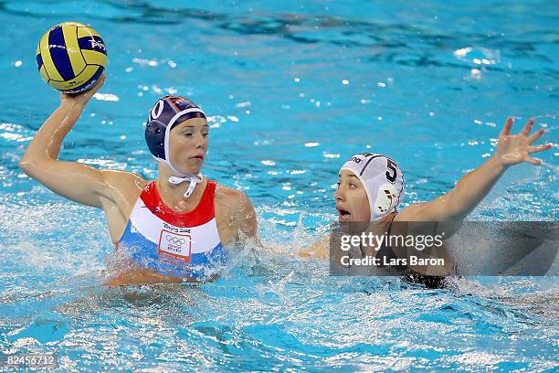 Alette Sijbring of Netherlands looks to pass over the defense of Mercedes Stieber of Hungary during the women's water polo semifinal round at the...