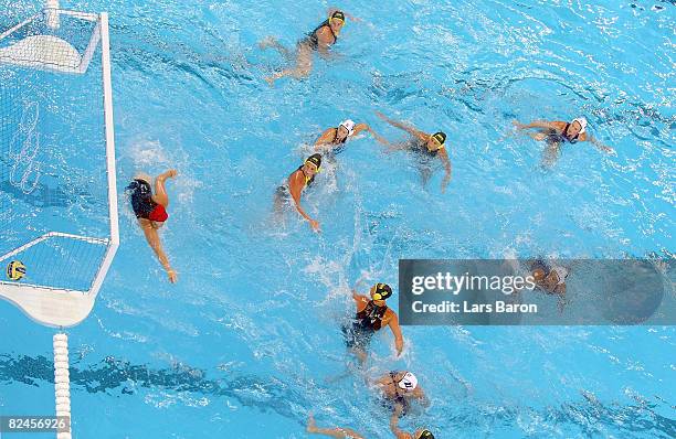 Brenda Villa of the United States scores over the defense of goalkeeper Alicia Mccormack Australia during the women's water polo semifinal round at...