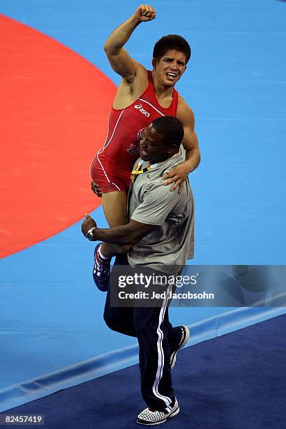 Henry Cejudo of the United States celebrates after defeating Shingo Matsumoto of Japan to win the gold medal in the men's 55kg freestyle wrestling...