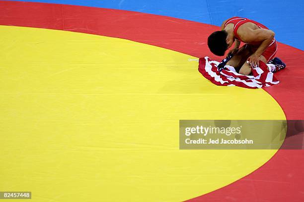 Henry Cejudo of the United States celebrates after defeating Shingo Matsumoto of Japan to win the gold medal in the men's 55kg freestyle wrestling...