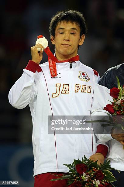 Silver medalist Shingo Matsumoto of Japan poses with his medal after the men's 55kg freestyle wrestling event at the China Agriculture University...