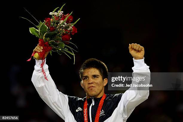 Henry Cejudo of the United States poses with his medal after defeating Shingo Matsumoto of Japan to win the gold medal in the men's 55kg freestyle...