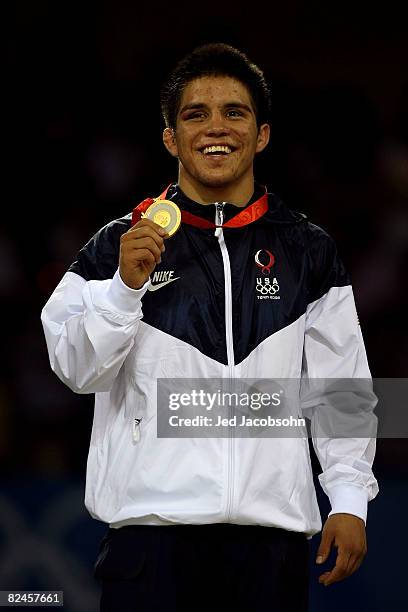 Henry Cejudo of the United States poses with his medal after defeating Shingo Matsumoto of Japan to win the gold medal in the men's 55kg freestyle...