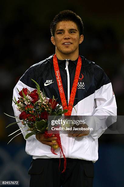 Henry Cejudo of the United States poses with his medal after defeating Shingo Matsumoto of Japan to win the gold medal in the men's 55kg freestyle...