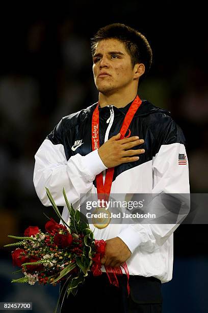 Henry Cejudo of the United States looks on during the national anthem after defeating Shingo Matsumoto of Japan to win the gold medal in the men's...