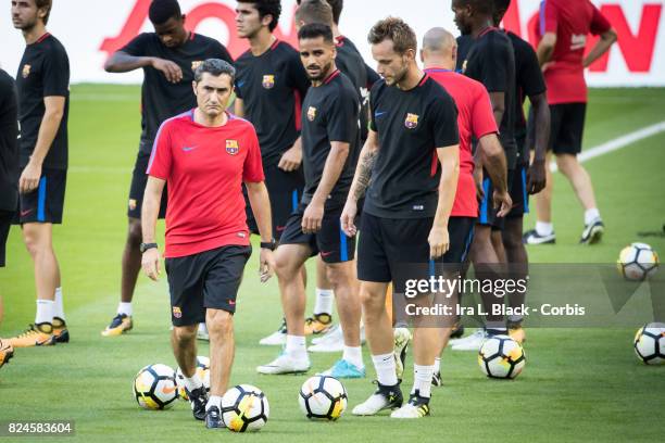 Head Coach Ernesto Valverde of Barcelona walks his players to the other side of the field during the training session for the International Champions...