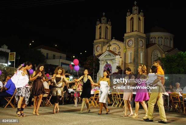 Greek People celebrate the christening of a baby with their traditional dance sirtaci on July 20, 2008 in Sianna, Rhodes, Greece. Rhodes is the...