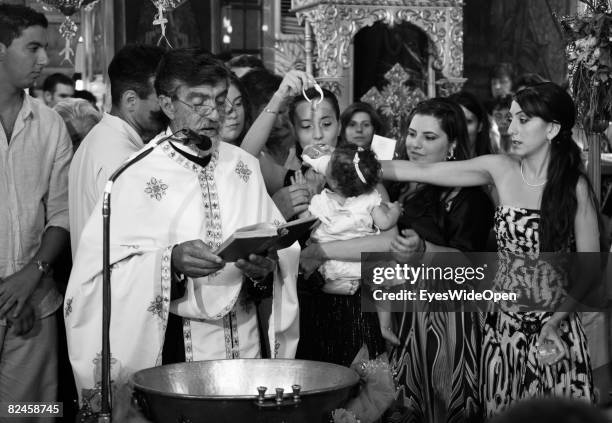 Greek People celebrate the christening of a baby on July 20, 2008 in Sianna, Rhodes, Greece. Rhodes is the largest of the greek Dodecanes Islands.