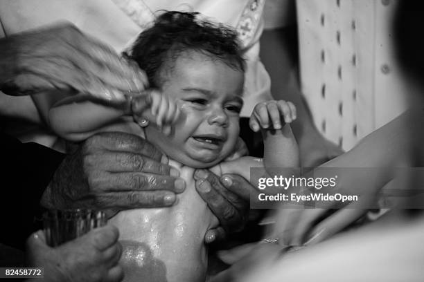 Greek People celebrate the christening of a baby on July 20, 2008 in Sianna, Rhodes, Greece. Rhodes is the largest of the greek Dodecanes Islands.