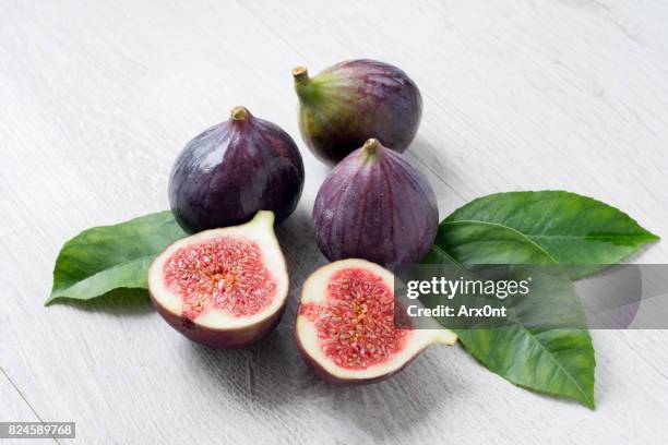 fresh figs with green leaf isolated - fig ストックフォトと画像