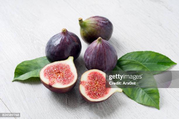 fresh figs with green leaf isolated - fig stock pictures, royalty-free photos & images