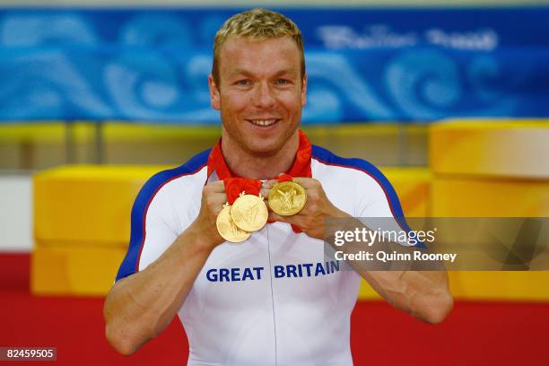 Chris Hoy of Great Britain celebrates with his three gold medals after defeating Jason Kenny of Great Britain in the Men's Sprint Finals in the track...