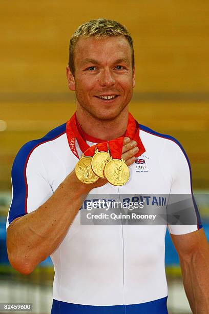 Chris Hoy of Great Britain celebrates with his three gold medals after defeating Jason Kenny of Great Britain in the Men's Sprint Finals in the track...