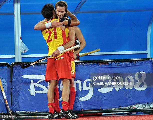 David Alegre and Eduard Arbos of Spain celebrate winning their 2008 Beijing Olympic Games preliminary men's field hockey match against South Korea in...