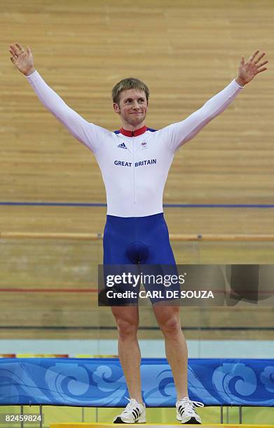 Track cyclist Jason Kenny of Great Britain celebrates on the podium before receiving the silver medal for the 2008 Beijing Olympic Games men's sprint...