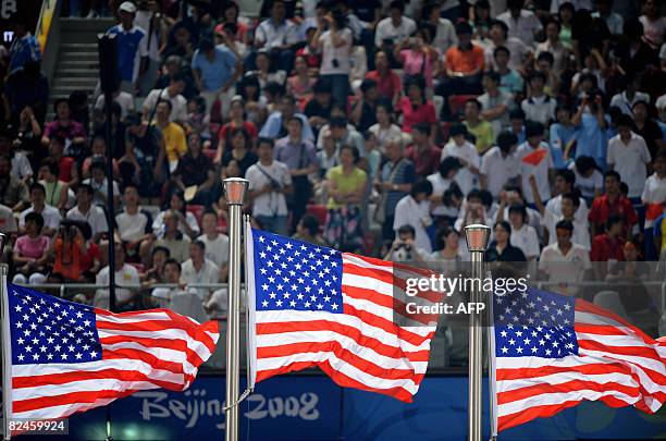 Three US flags for US gold medalist Angelo Taylor, US silver medalist Kerron Clement and US bronze medalist Bershawn Jackson are pictured during the...