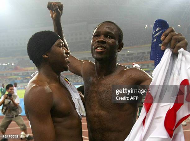 Nigeria's Olubayo Adefemi celebrates with teammate goalkeeper Ambruse Vanzekin after their victory over Belgium during their 2008 Beijing Olympic...