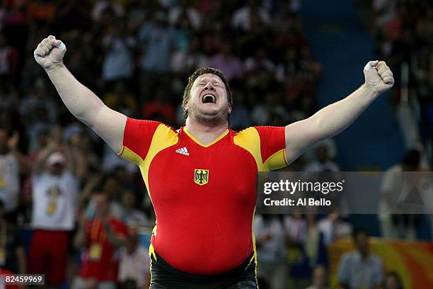 Matthias Steiner of Germany celebrates winning the gold medal in the Men's 105 kg group weightlifting event at the Beijing University of Aeronautics...