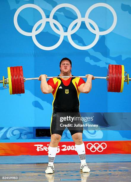 Matthias Steiner of Germany completes his final lift to win the gold medal in the Men's 105 kg group weightlifting event at the Beijing University of...