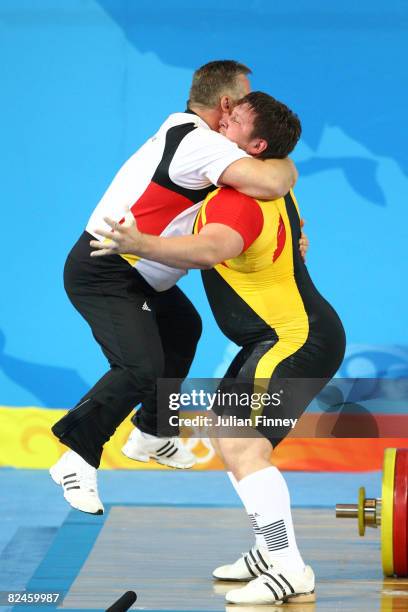 Matthias Steiner of Germany celebrates winning the gold medal in the Men's 105 kg group weightlifting event with his coach Frank Mantek at the...