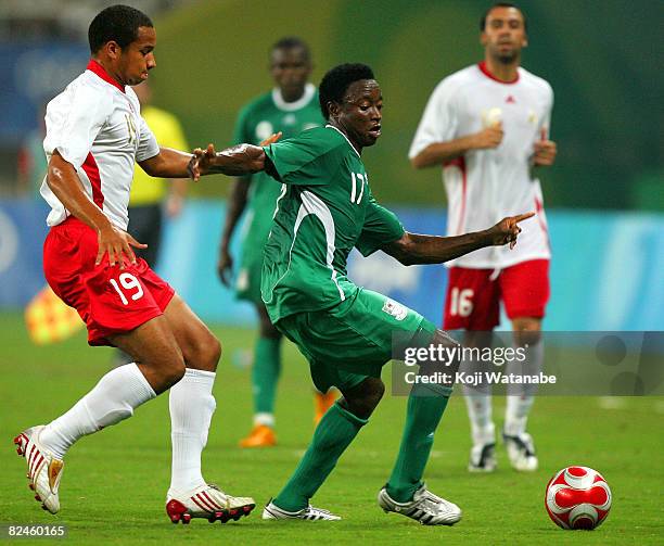 Emmanuel Ekpo of Nigeria and Vadis Odjidja-Ofoe of Belgium compete for the ball during the Men's Semi Final match between Nigeria and Belgium at...